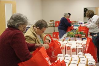 WOM packing bags of food to provide meals for Christmas for parents of Wednesday night Youth group.